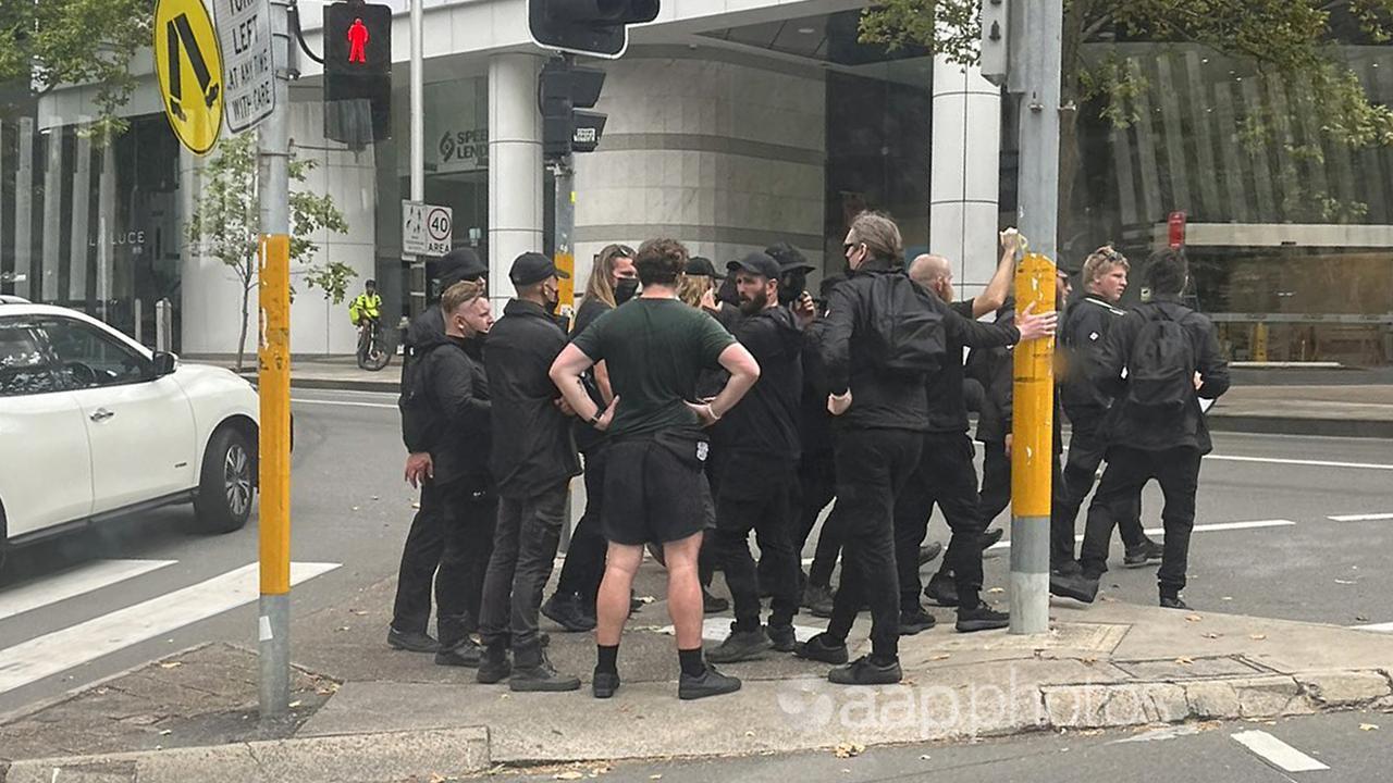 A group of men in black who swarmed a train in Sydney.