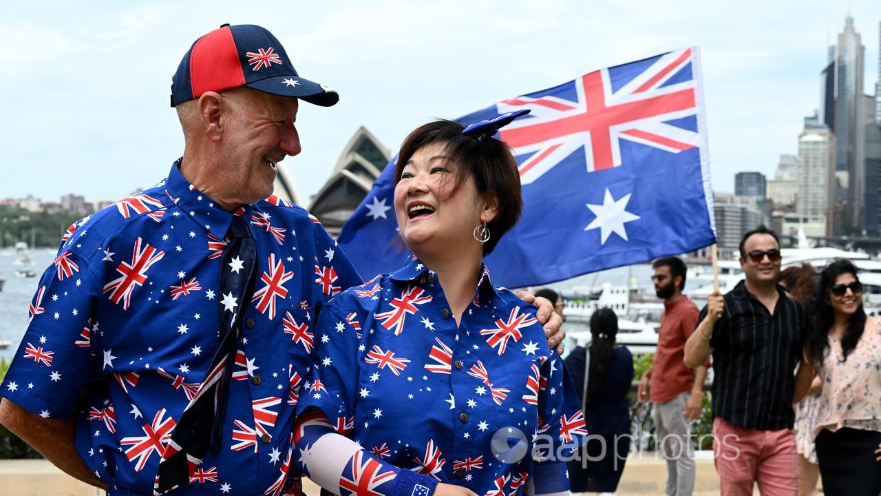 Man and woman dressed in Australian flag shirt and pants 