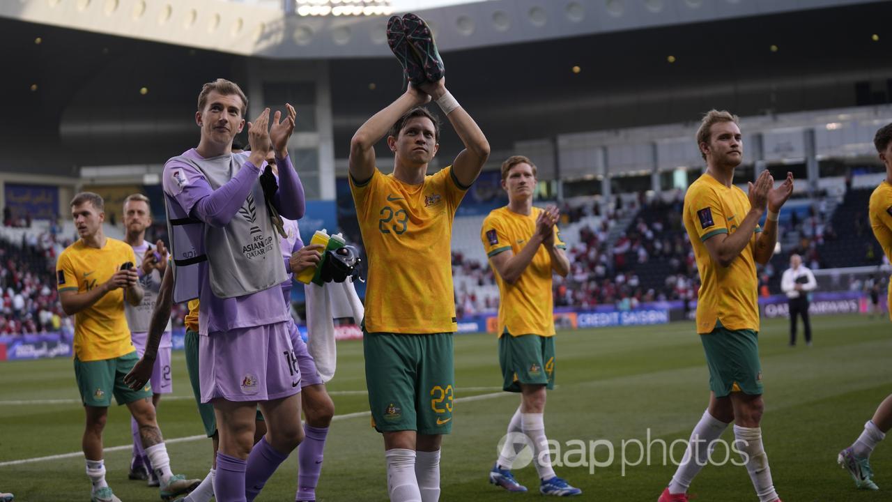 Socceroos players acknowledge the fans.