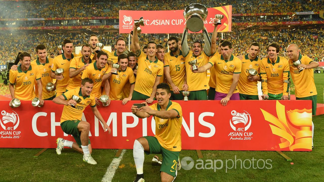 Socceroos players celebrate winning the Asian Cup final.