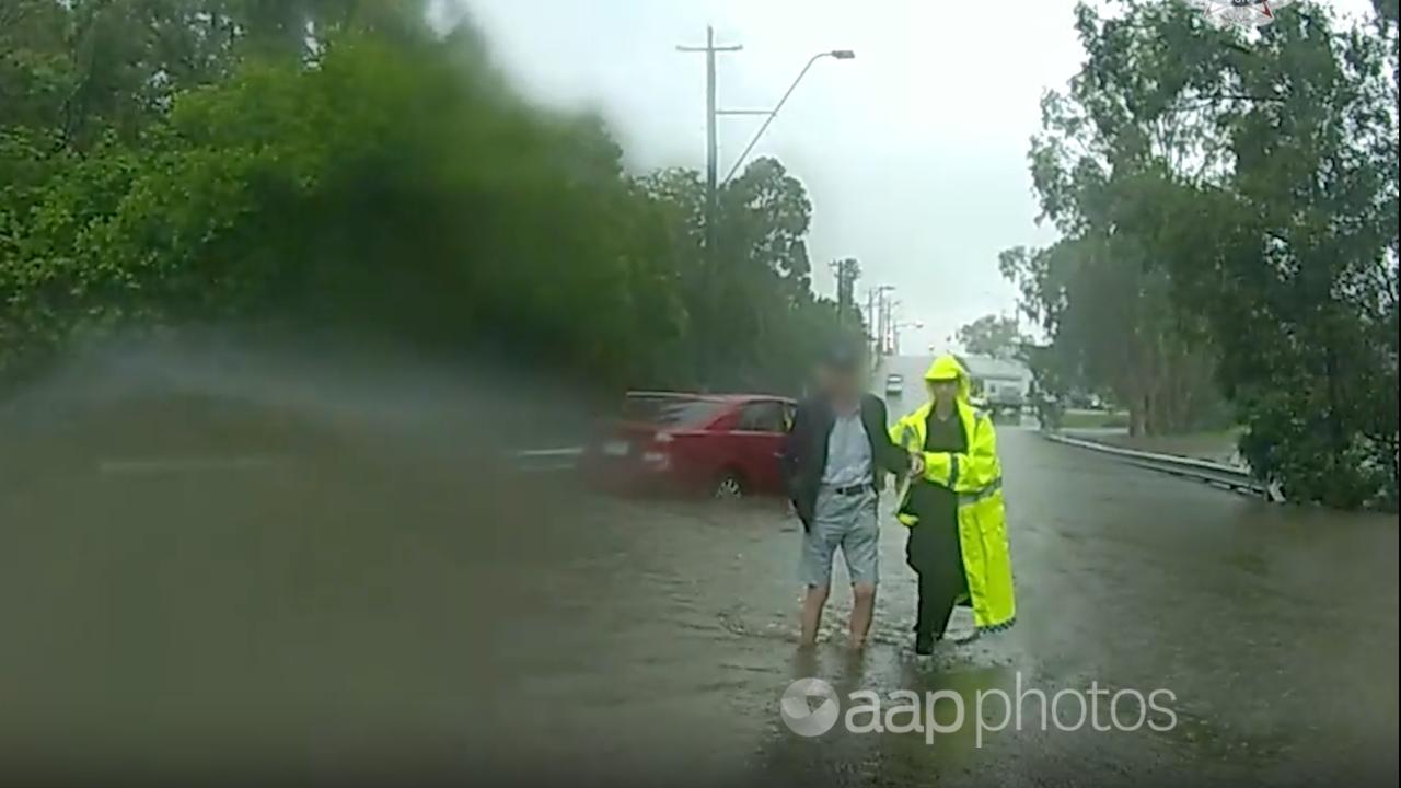 A driver being assisted in a flood zone