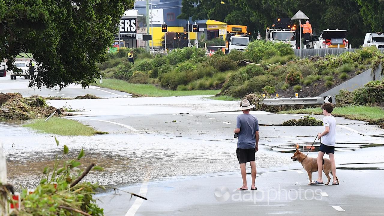 People near a flooded South Pine River in Strathpine.