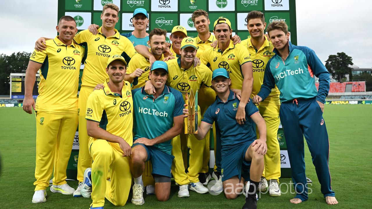 Australia players pose with the trophy after their third ODI win.