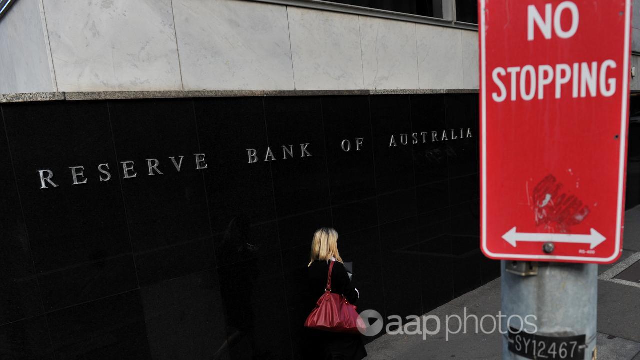 A woman passes the RBA building in Sydney (file image)