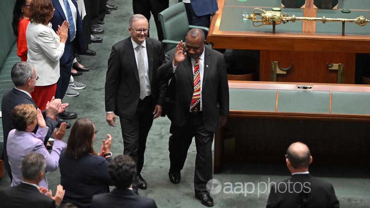 Anthony Albanese with James Marape on the floor of the house.