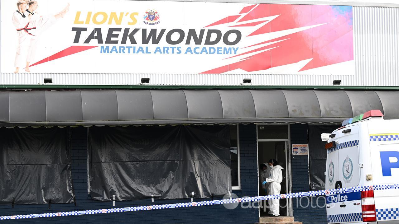 Police combed a taekwondo studio where two bodies were found.