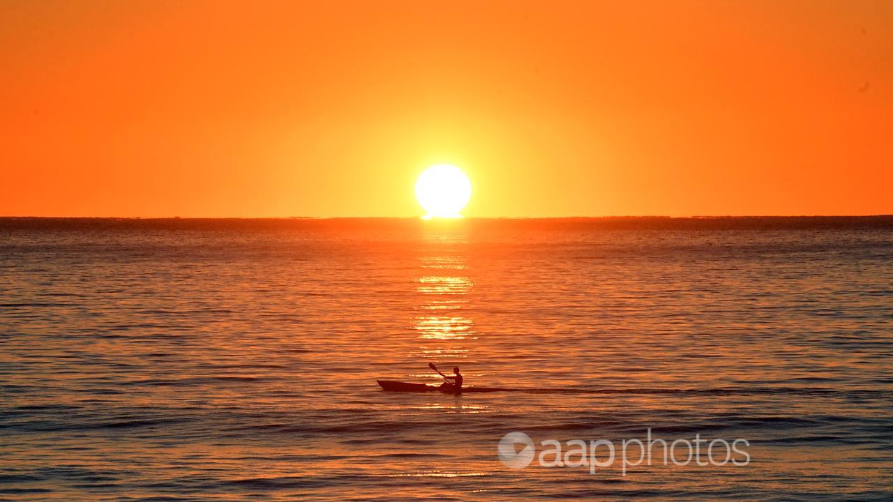 A kayaker paddles at sunrise (file image)