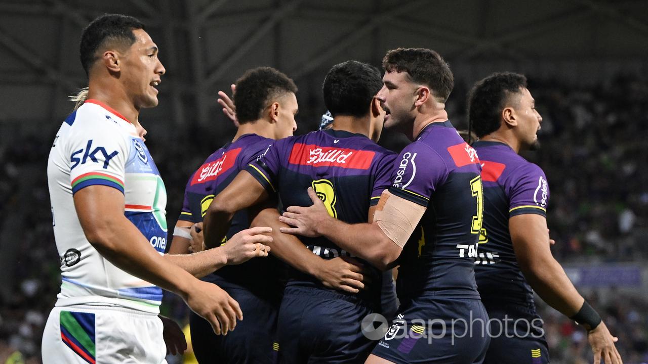 Melbourne Storm players celebrate a try.