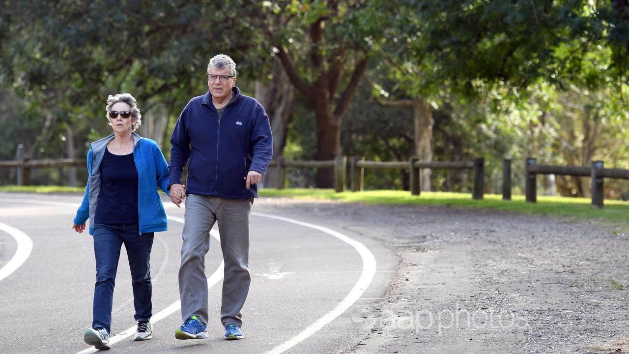 An elderly couple walk through a park in Sydney (file)