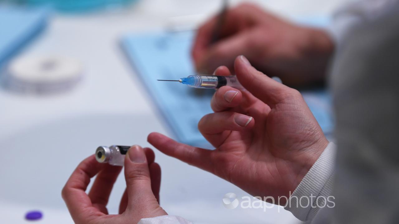 A healthcare worker handles a COVID-19 vaccination (file image)