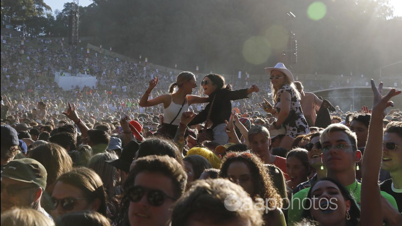 People crowd-surfing at a music festival.