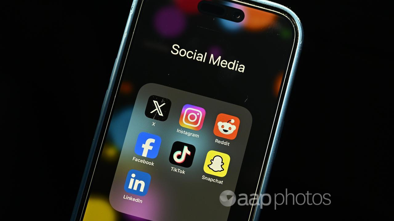 A phone displaying various social media apps