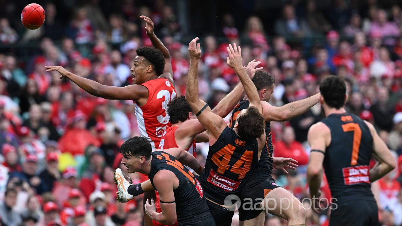 Sydney and GWS players contest a high ball.