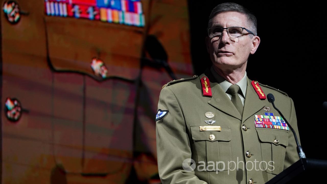 General Angus Campbell standing at a lectern.