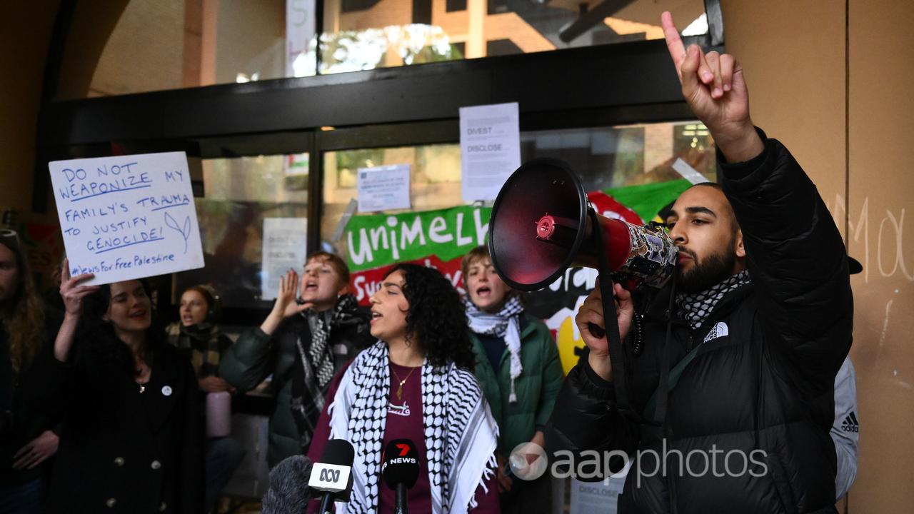 Student chant at a pro-Palestine camp at the University of Melbourne