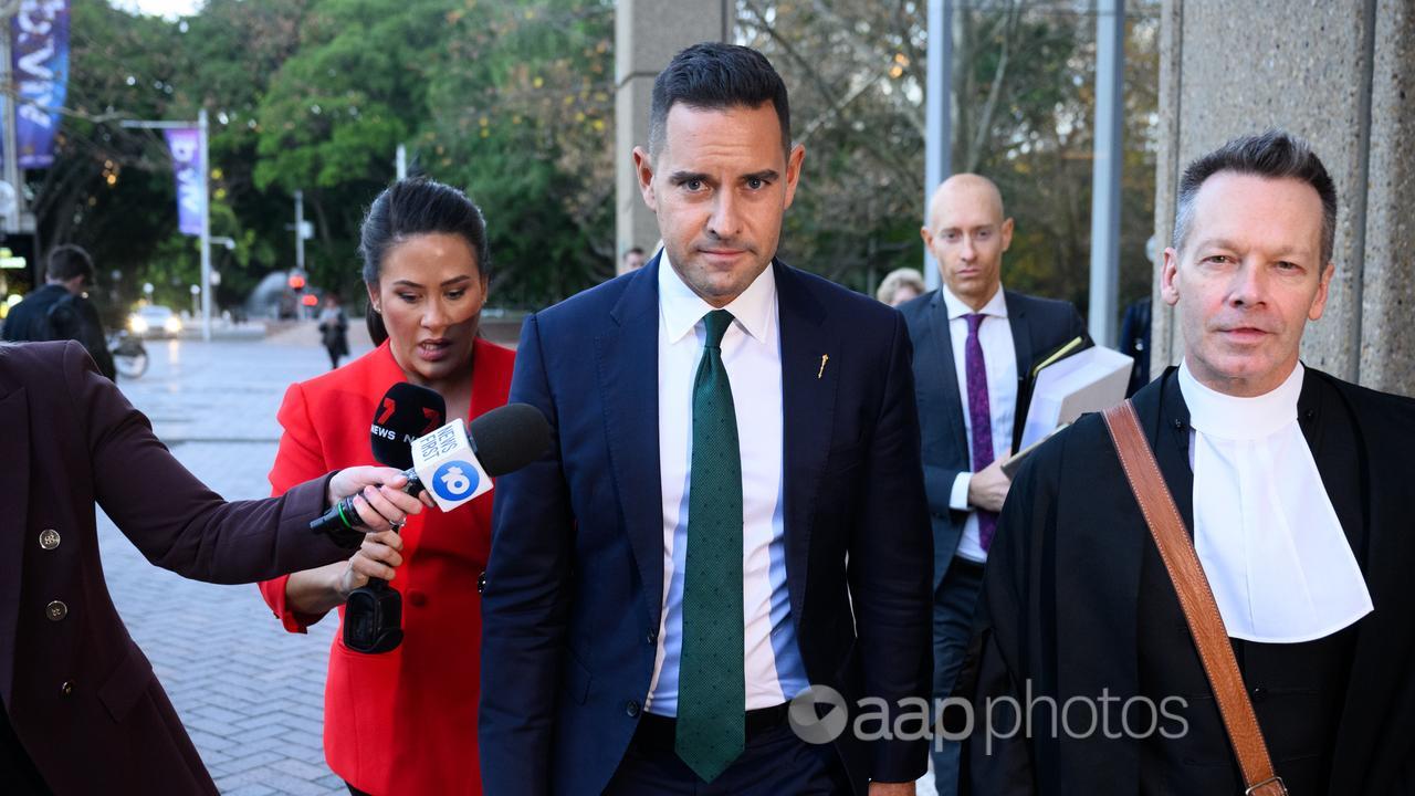 Alex Greenwich (centre) leaves the Federal Court