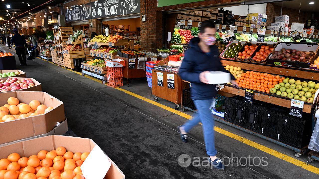 Person walking past market