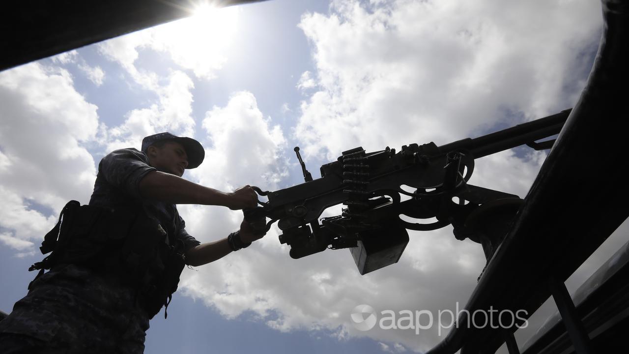 A Houthi soldier mans a machine gun on a vehicle on patrol in Yemen