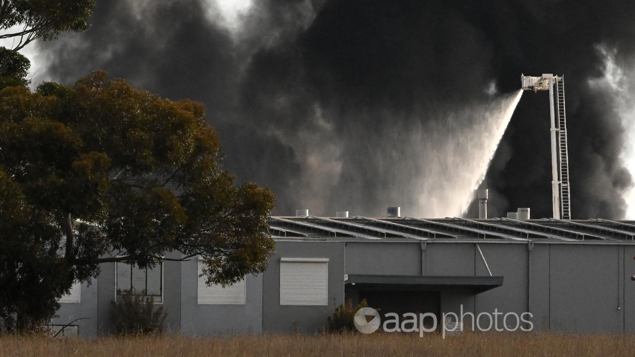 Firefighters battle a large factory