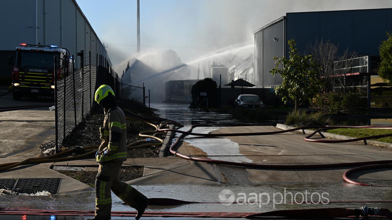 Firefighters contain the factory blaze.