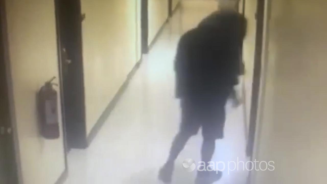 Image of person leading motel room of murder victims