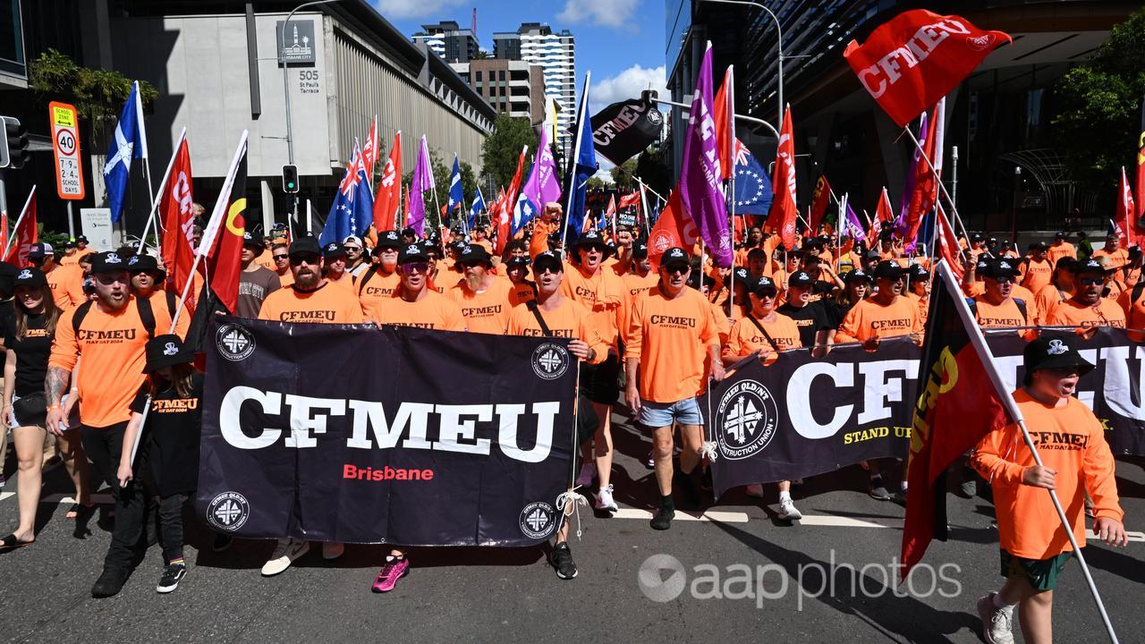 Members of the CFMEU and other people participate in a march