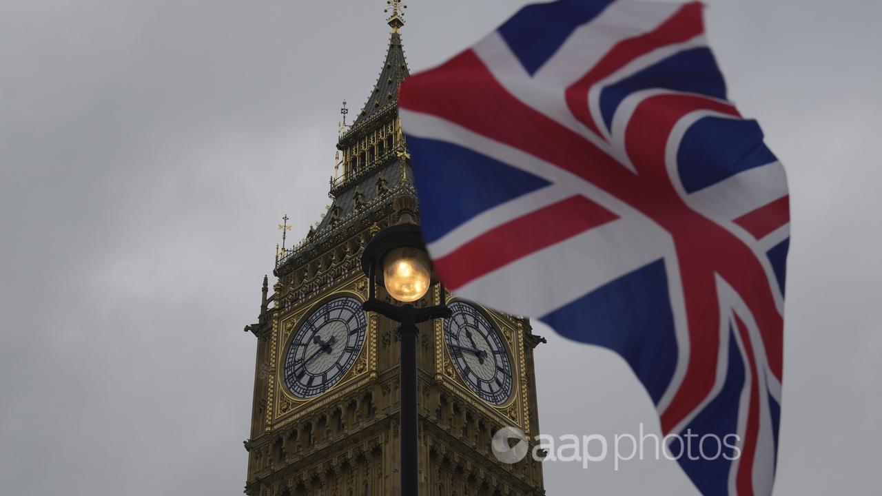 A Union flag is displayed outside the Houses of Parliament in London