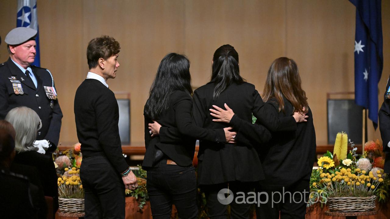 Family members place a wreath at an MH17 ceremony in Canberra