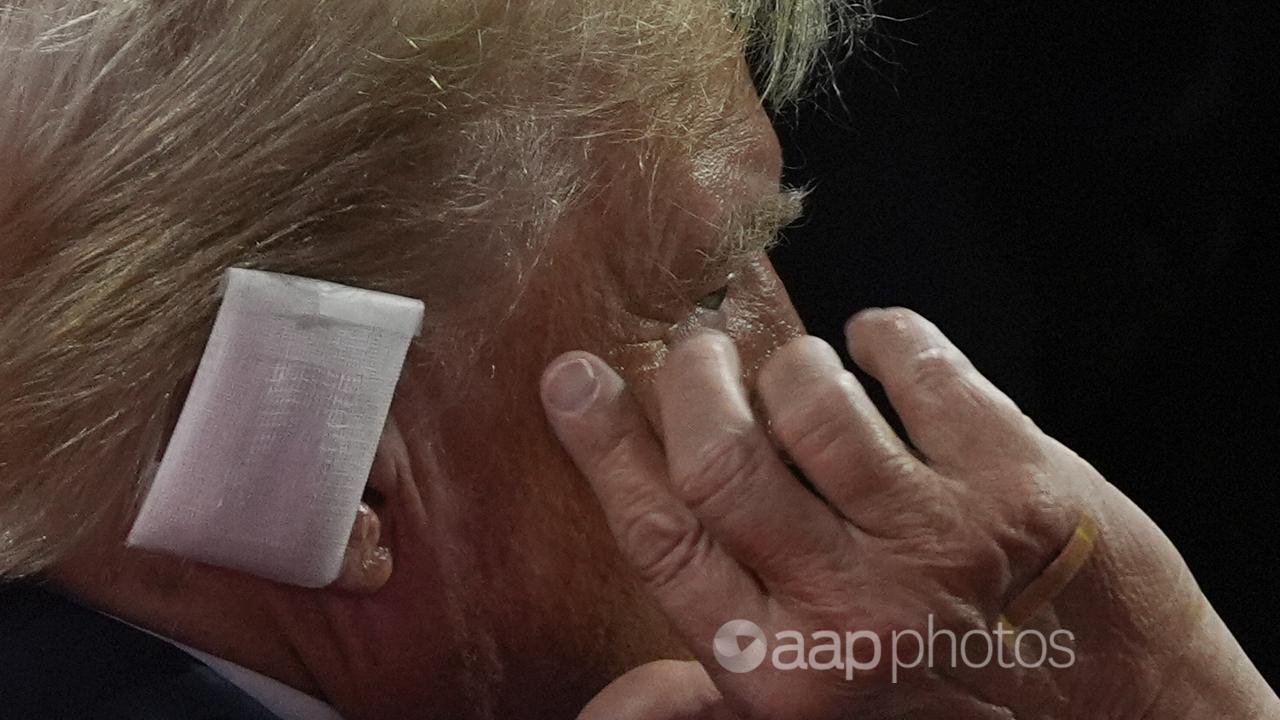 Donald Trump points to his ear at the Republican National Convention.