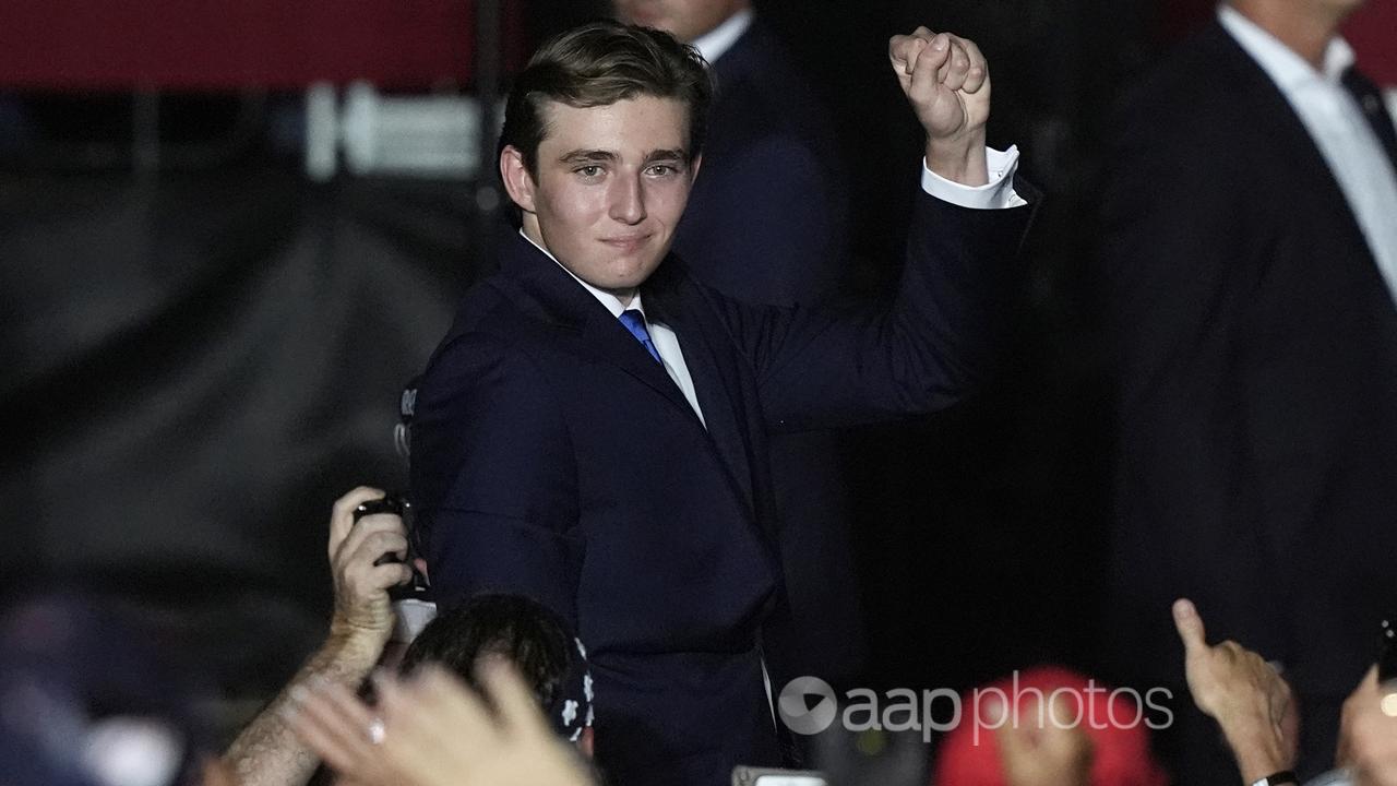 Barron Trump gestures after his father is introduced at a rally.