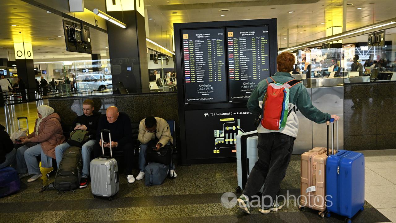 People wait at an airport.