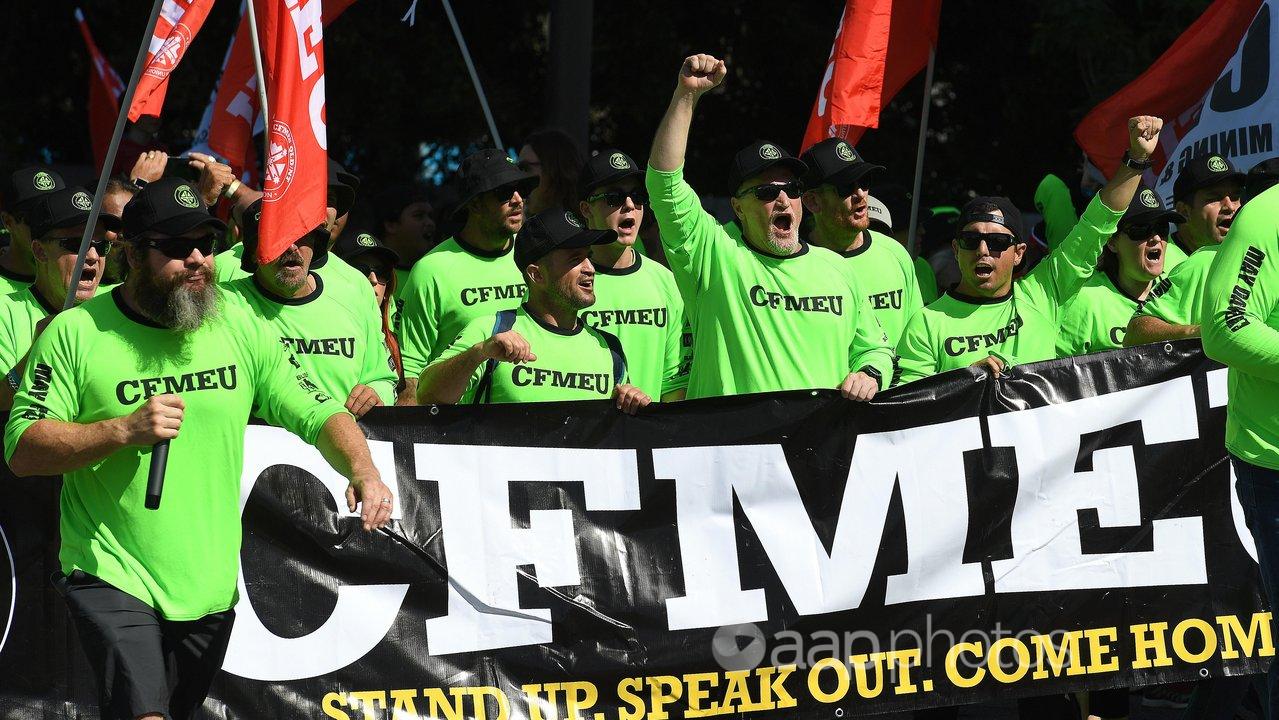 Union members wearing CFMEU shirts during a march