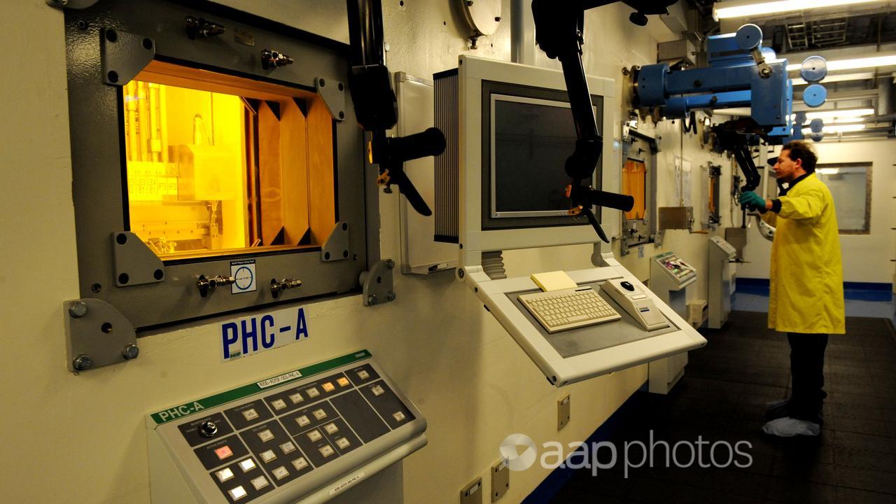 A technician uses a hot cell at Lucas Heights.