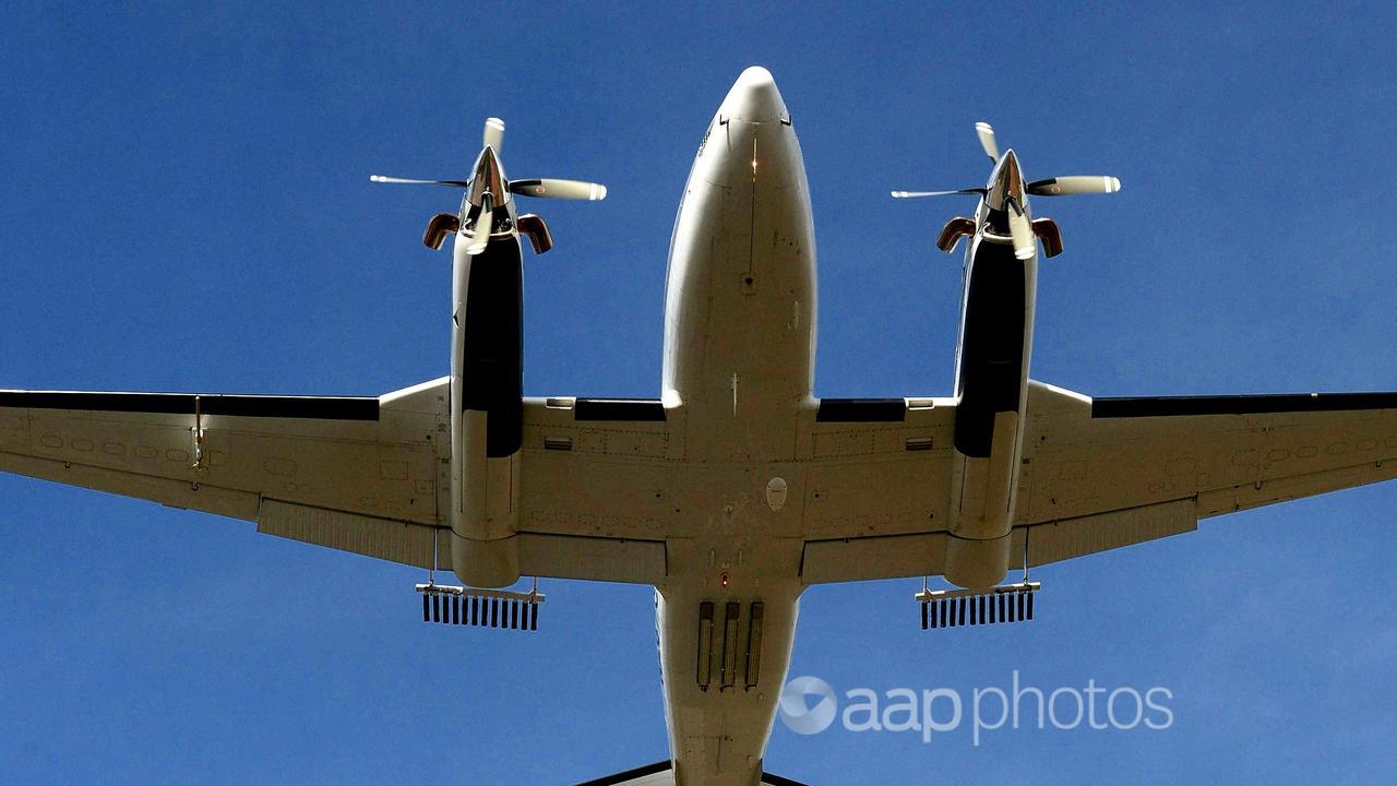 An aircraft fitted with cloud seeding cannisters.