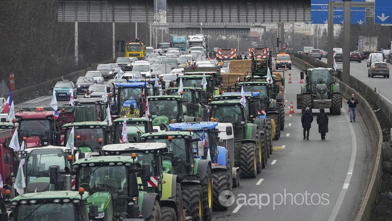 Tractors line up on a blocked highway north of Paris.