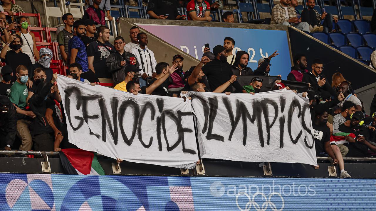 Protesters against Israel's inclusion hold a banner at a soccer match