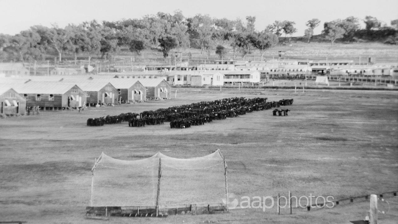 Japanese PoWs bow to the rising sun at the Cowra camp.