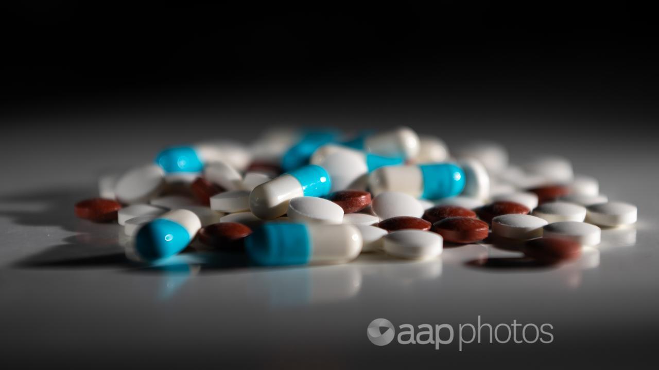 A pile of medicine tablets on a table