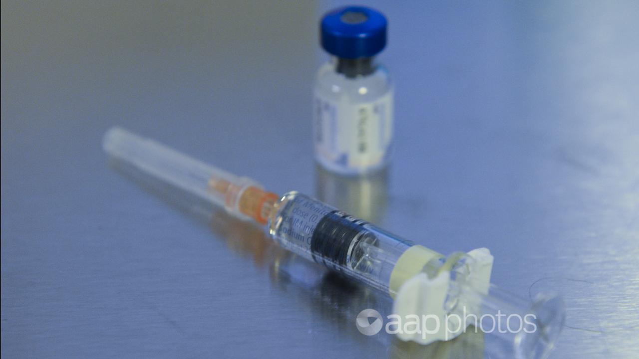 Close up of a vaccine and syringe.