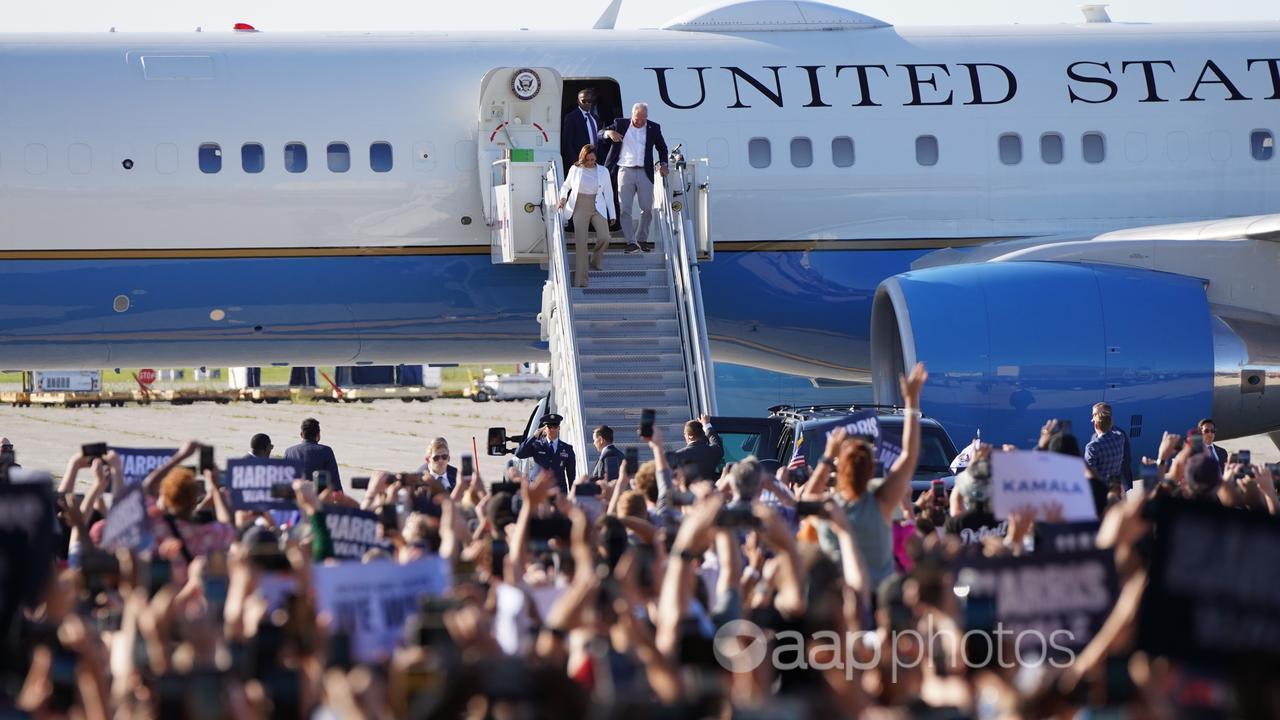 Kamala Harris and Tim Walz disembarking plane in Detroit.