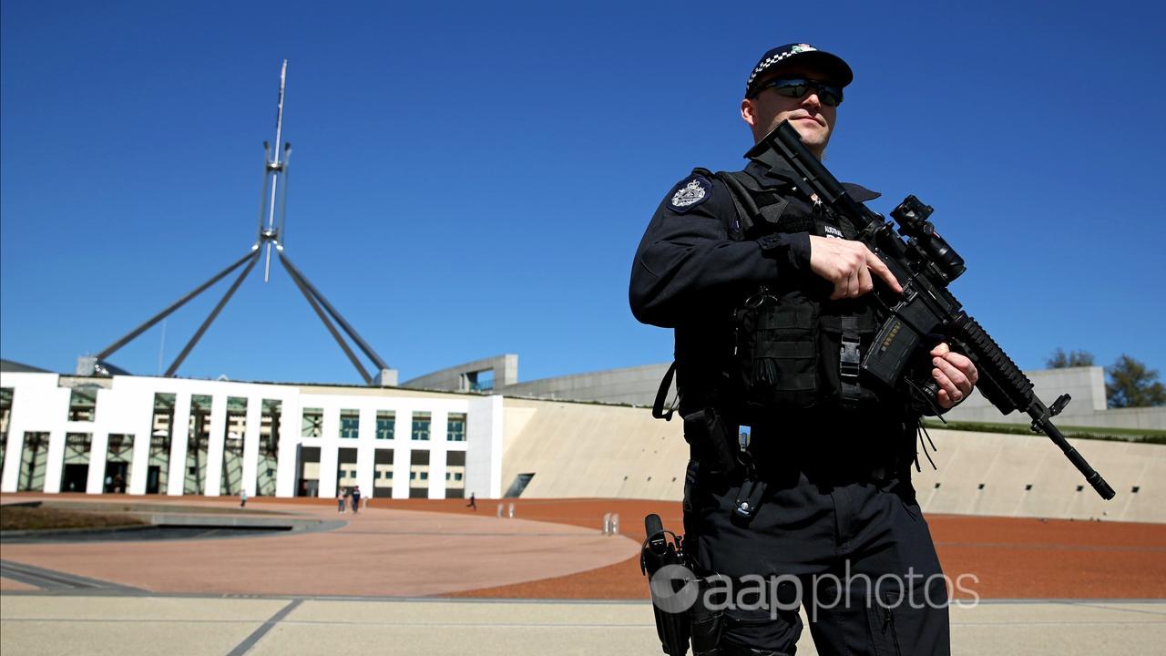 Australian Federal Police officers patrol Parliament House