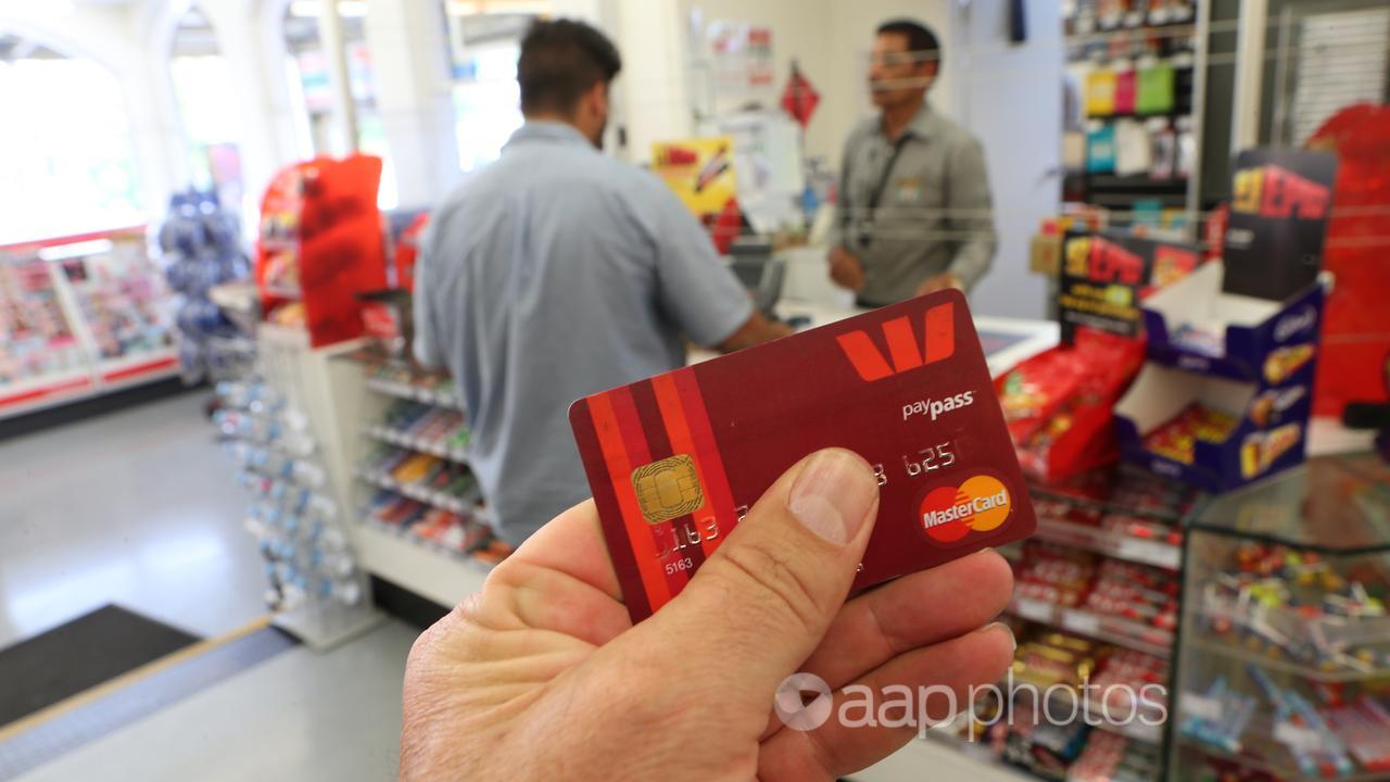 A customer using a tap-and-go credit card (file)