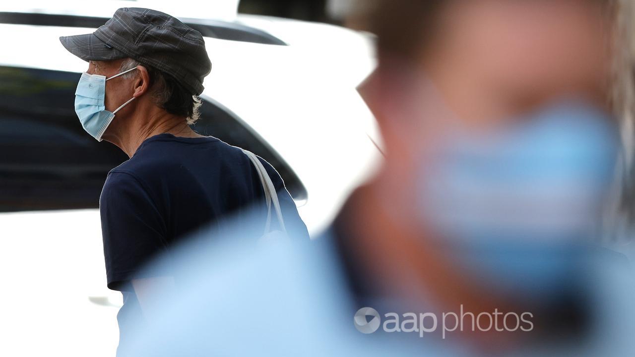 Pedestrians wear face masks in Brisbane