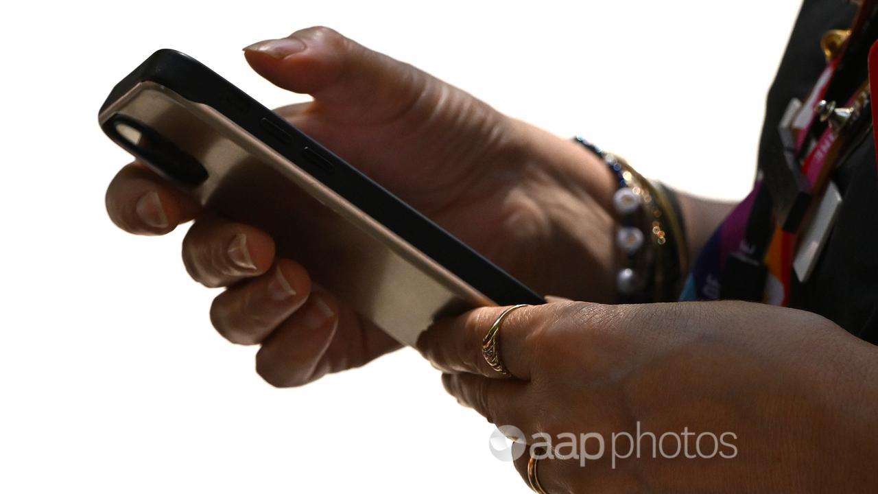 A woman seen using a smartphone device