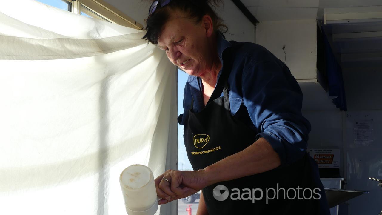 Pam Bertalli salts the chips in her van.