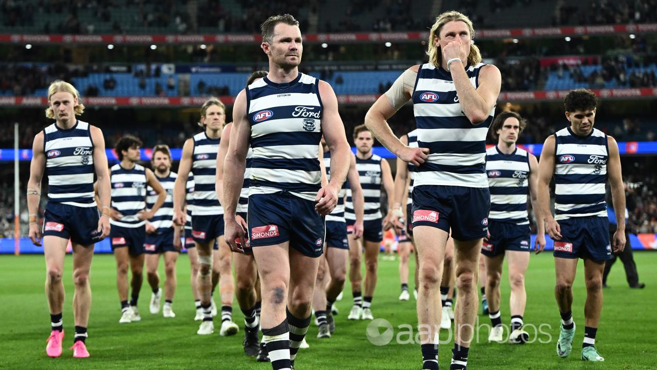 Geelong players leave MCG after defeat.