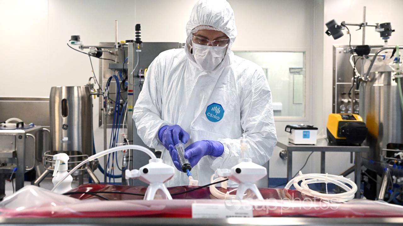 A scientist working in a cell culture suite in a vaccine laboratory.