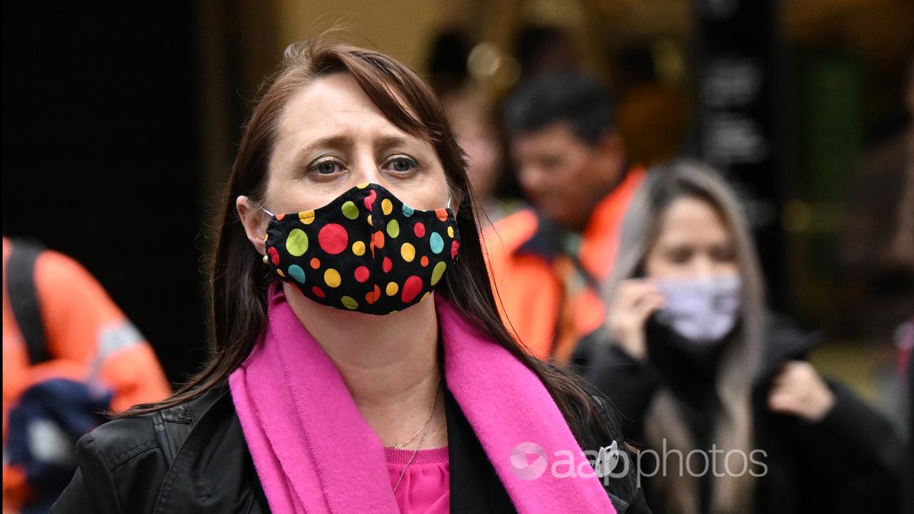 A woman wearing a colour face mask.