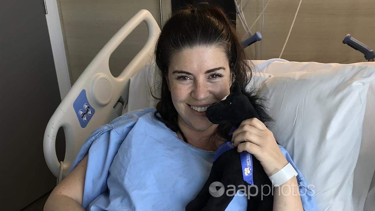 Kate Browne posing for a photograph in hospital