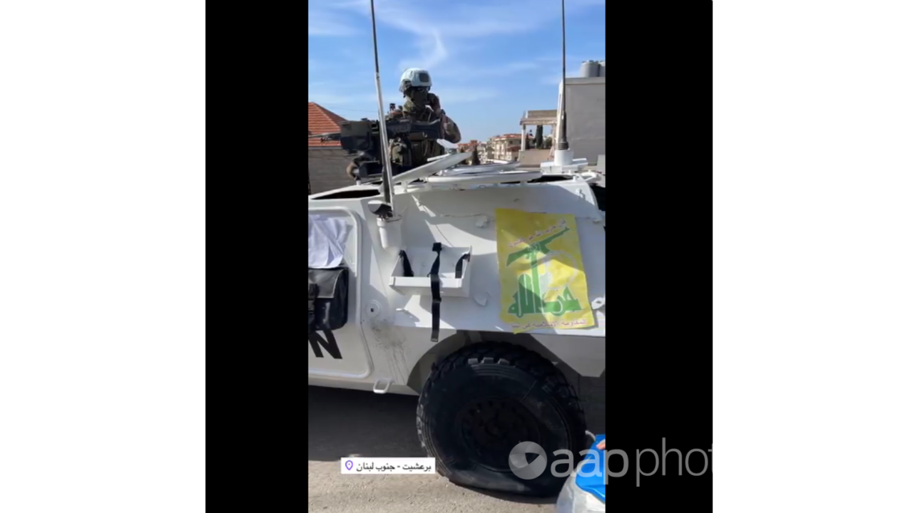 Close-up of punctured tyre on UNIFIL vehicle bearing Hezbollah flag.